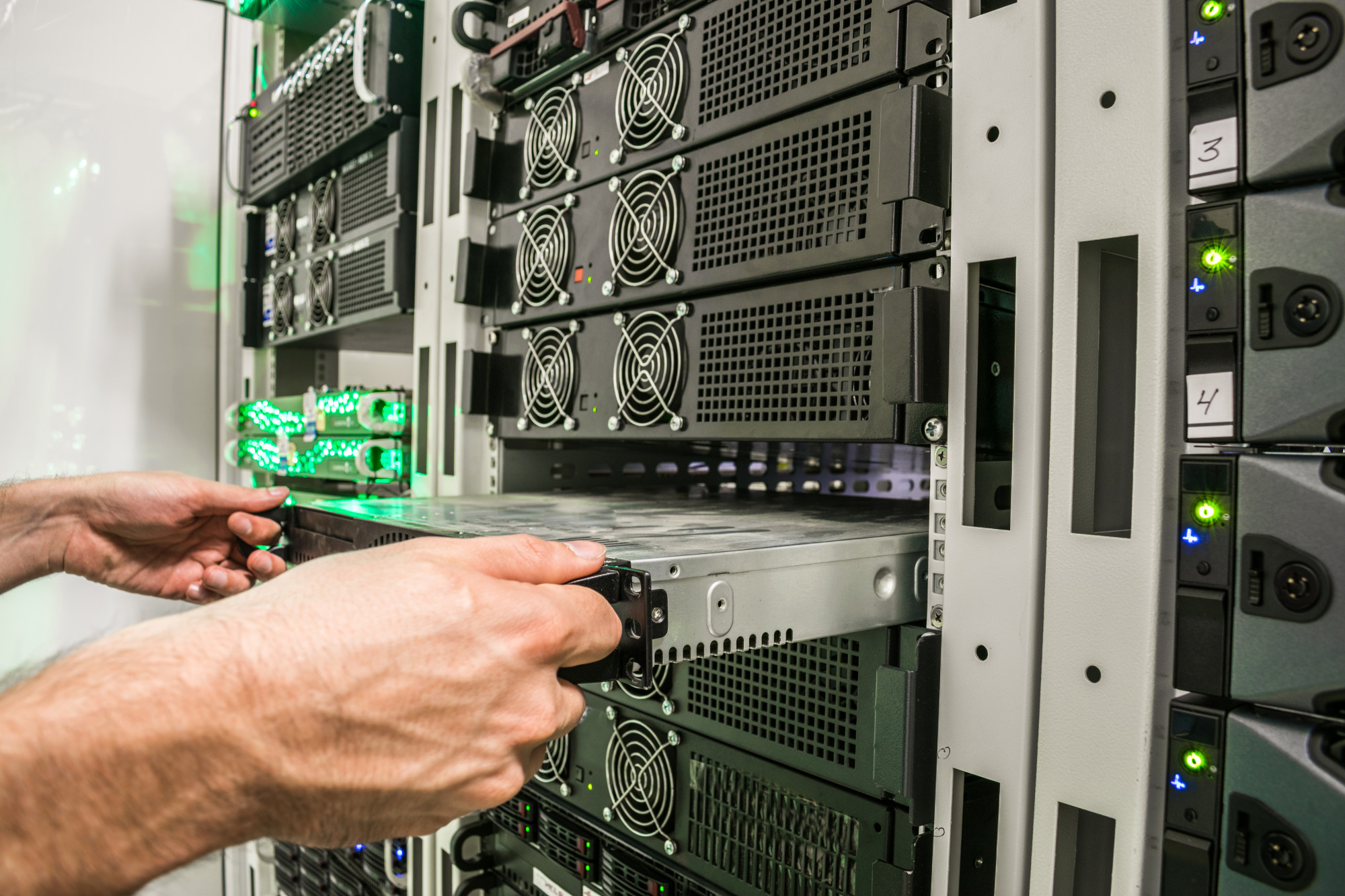 Adobe Stock photo of IT Technician making equipment adjustments.